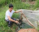 Wu Shibin，Farmhouse owner in Yuanshan Village, Guangyuan City, Sichuan province showing the cesspit he built to collect wastewater. July 2013